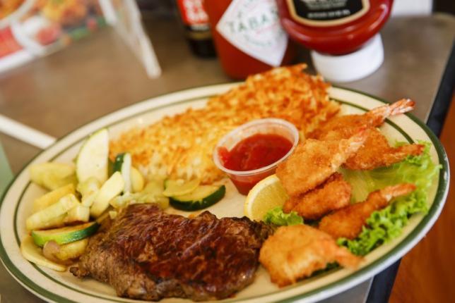 A steak and fried shrimp combo plate is served to a customer at Norms Diner on La Cienega Boulevard in Los Angeles, California May 20, 2015.  REUTERS/Patrick T. Fallon